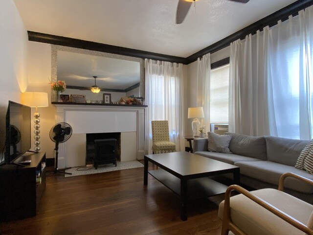 living room featuring ceiling fan, hardwood / wood-style flooring, and ornamental molding