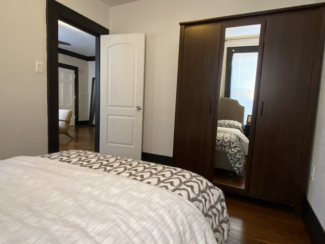 bedroom with dark wood-type flooring