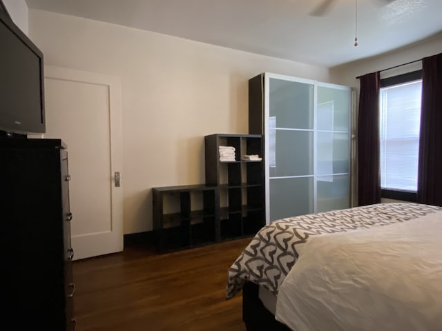 bedroom featuring ceiling fan and dark hardwood / wood-style flooring