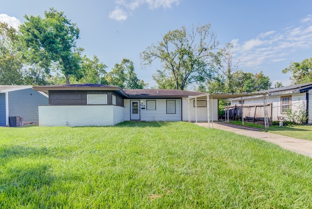 single story home featuring a carport and a front yard