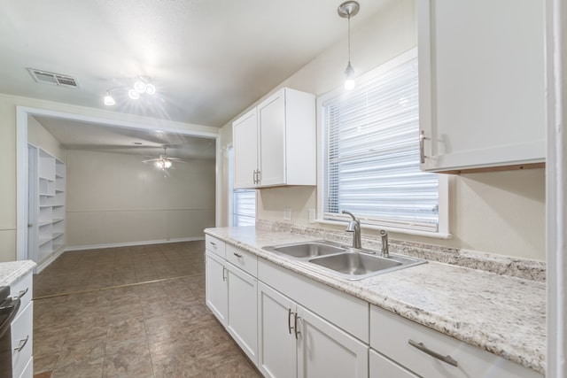 kitchen featuring sink, light tile patterned floors, white cabinetry, ceiling fan, and hanging light fixtures