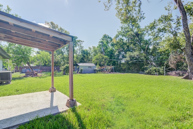 view of yard featuring central AC unit and a patio area