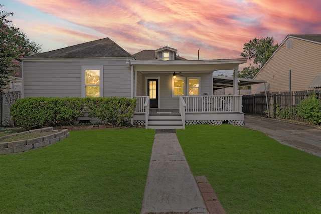 view of front of home with a porch and a yard