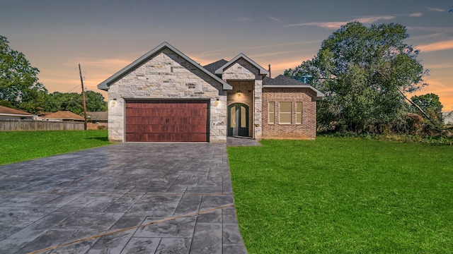 view of front of property with a lawn and a garage