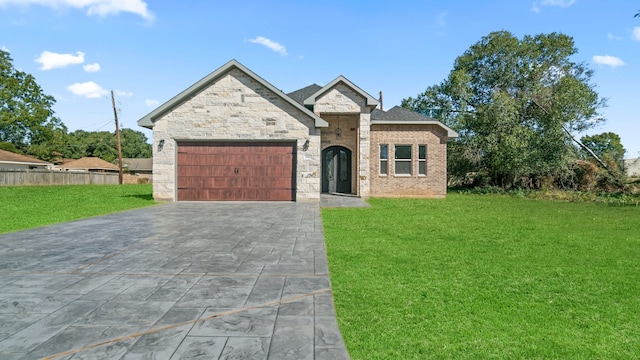 view of front of house with a garage and a front lawn