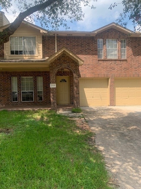 view of front facade with a garage and a front yard