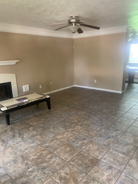 tiled spare room with ceiling fan, crown molding, and a textured ceiling