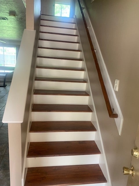 staircase with tile patterned floors