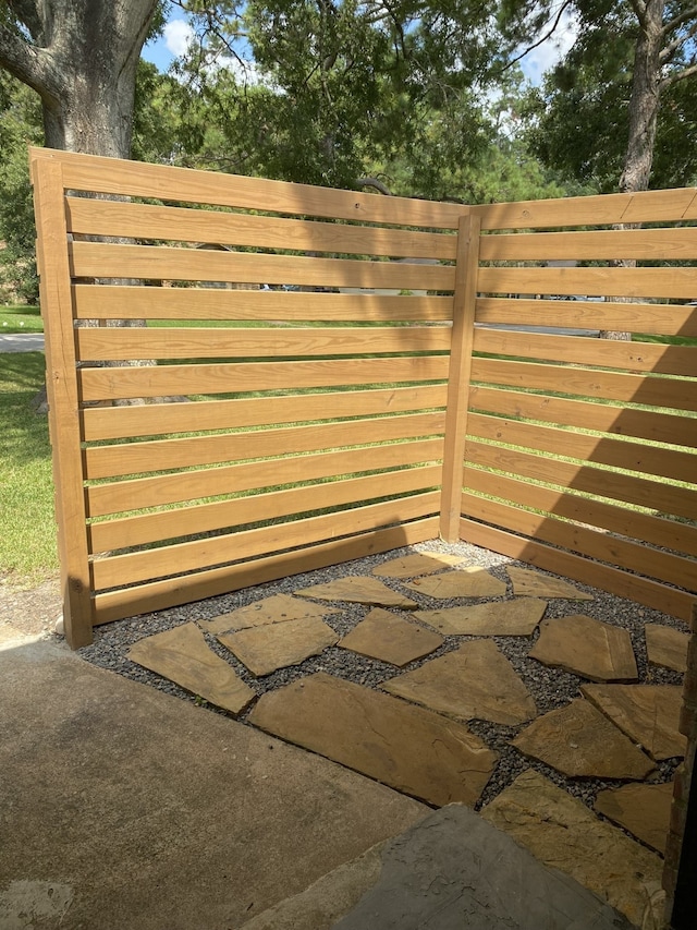 view of gate with a patio