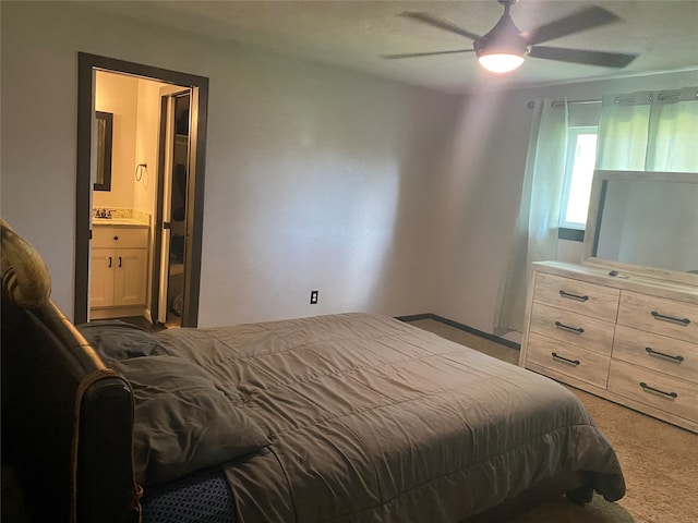 carpeted bedroom featuring ensuite bathroom, ceiling fan, and sink