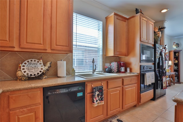 kitchen featuring light tile patterned floors, sink, ornamental molding, and black appliances