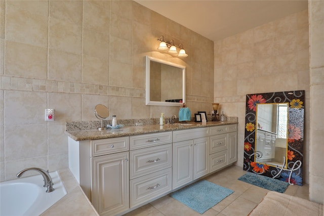 bathroom with tile patterned floors, vanity, and tile walls