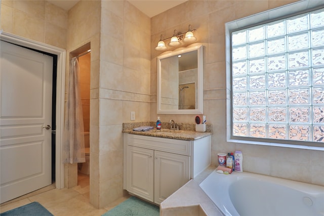 bathroom featuring tile walls, independent shower and bath, vanity, and tile patterned floors