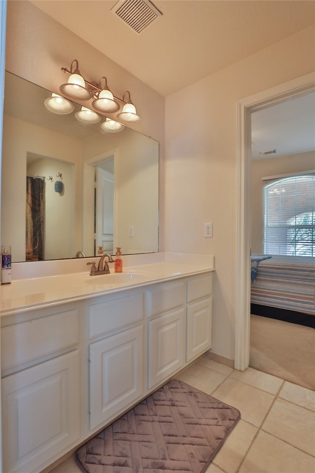 bathroom featuring tile patterned flooring and vanity