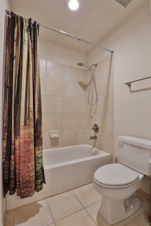 bathroom with tile patterned flooring, shower / bath combo, and toilet