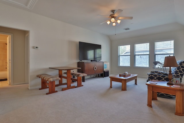 living room featuring ceiling fan, light carpet, and lofted ceiling