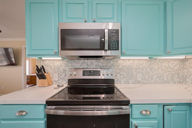 610 Surf Dr, Surfside Beach, TX 77541 - kitchen featuring ornamental molding, appliances with stainless steel finishes, blue cabinetry, and light countertops