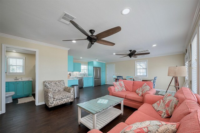 610 Surf Dr, Surfside Beach, TX 77541 - living room with crown molding, a ceiling fan, visible vents, and baseboards