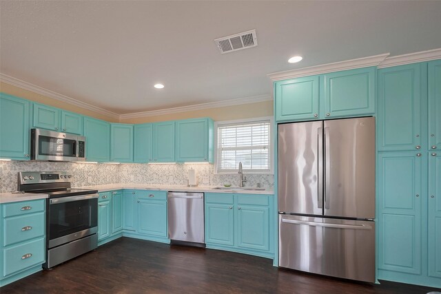 610 Surf Dr, Surfside Beach, TX 77541 - kitchen with a sink, stainless steel appliances, visible vents, light countertops, and ornamental molding