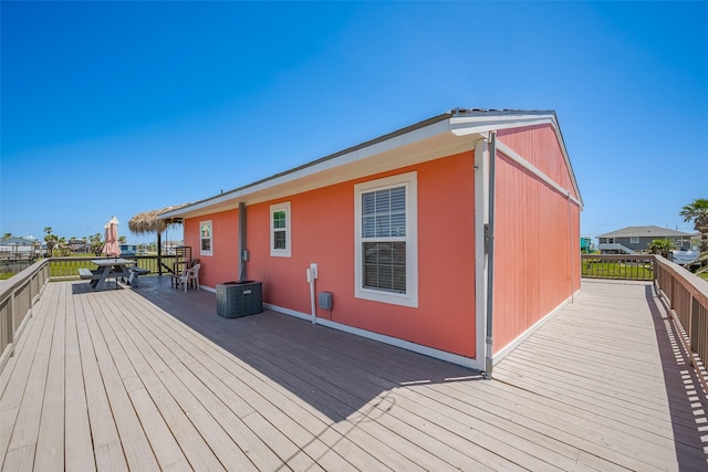 610 Surf Dr, Surfside Beach, TX 77541 - wooden deck featuring outdoor dining space and central AC