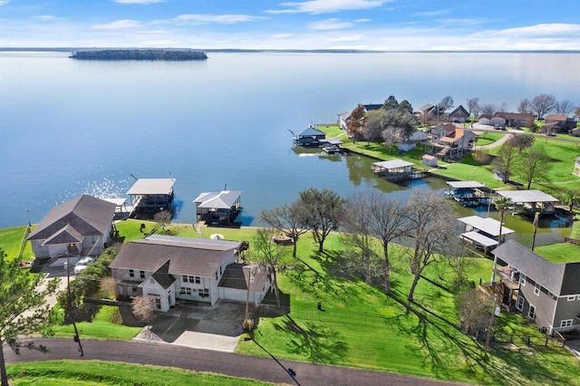 birds eye view of property with a water view and a residential view