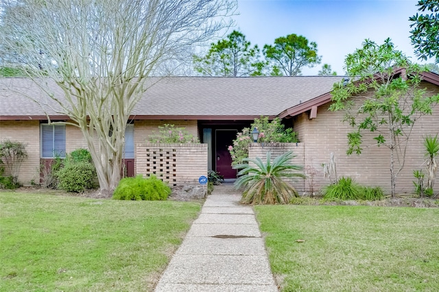 ranch-style house with a front lawn