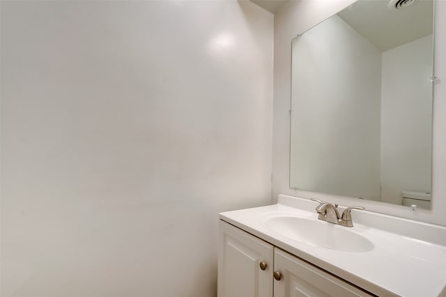 bathroom with toilet and vanity