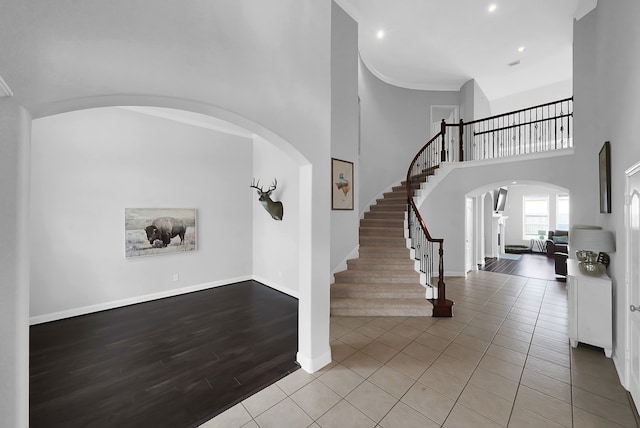 entrance foyer with a high ceiling and light hardwood / wood-style flooring