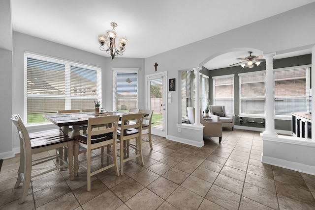 dining area featuring tile patterned flooring, ceiling fan with notable chandelier, and a healthy amount of sunlight