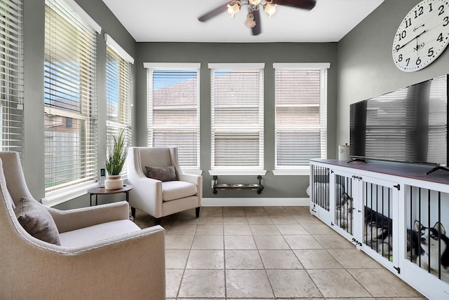 sitting room with ceiling fan and light tile patterned floors