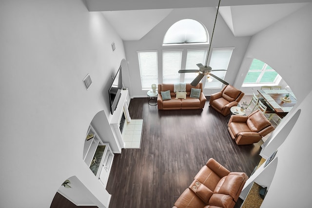 living room with ceiling fan, high vaulted ceiling, and dark hardwood / wood-style floors