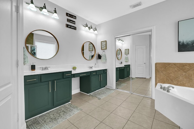 bathroom with a bath, tile patterned flooring, and vanity