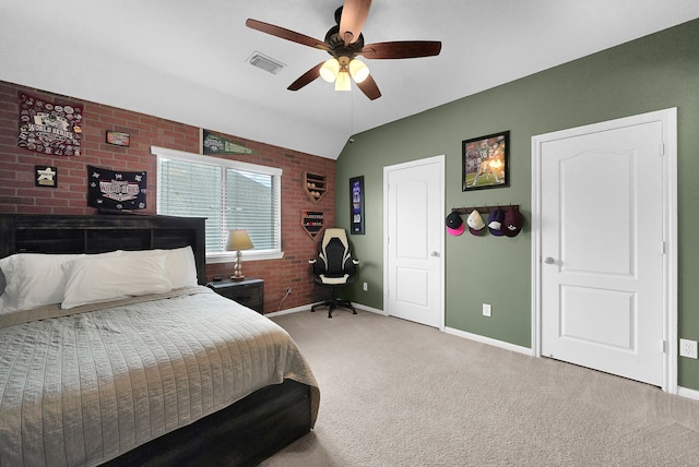 carpeted bedroom featuring ceiling fan, vaulted ceiling, and brick wall