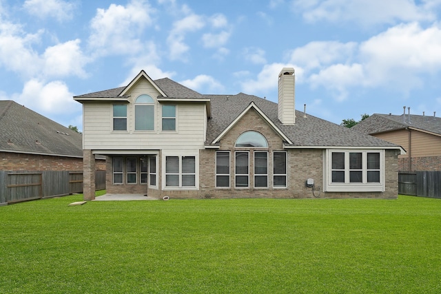 back of house featuring a patio and a yard