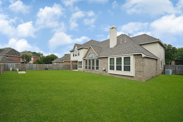 rear view of house featuring a lawn