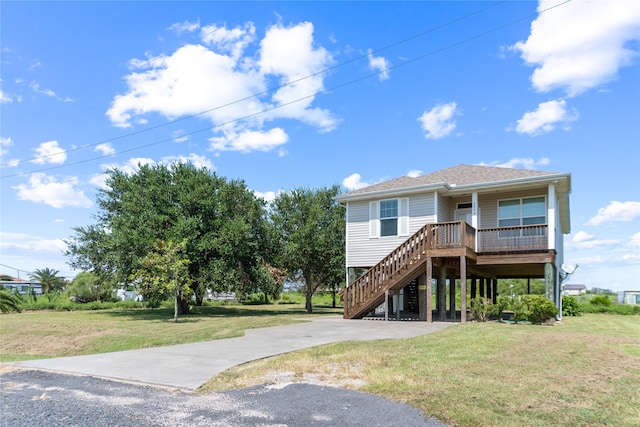 raised beach house featuring a front yard