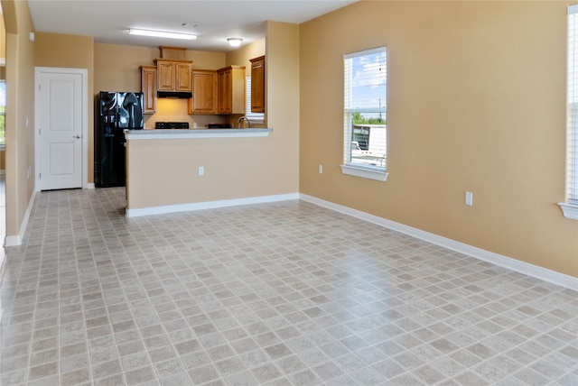 kitchen featuring fridge and light tile patterned flooring