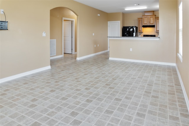 unfurnished living room featuring light tile patterned flooring