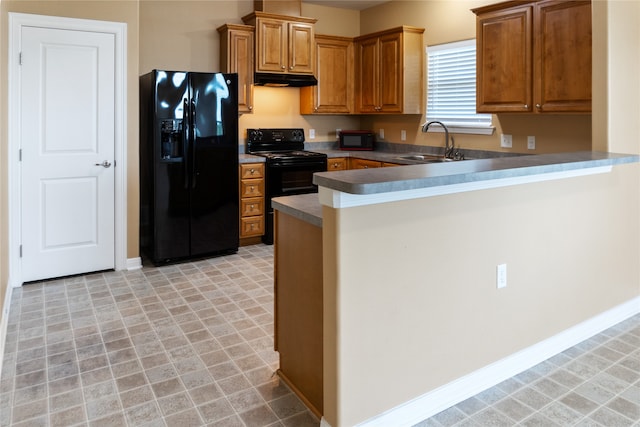 kitchen with sink, kitchen peninsula, black appliances, and light tile patterned floors