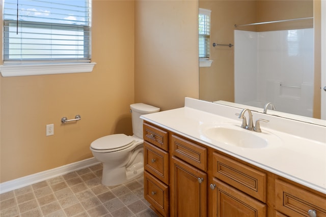 bathroom featuring tile patterned floors, vanity, a shower, and toilet