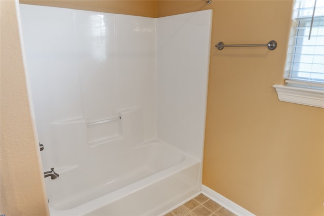 bathroom featuring tile patterned flooring and bathing tub / shower combination