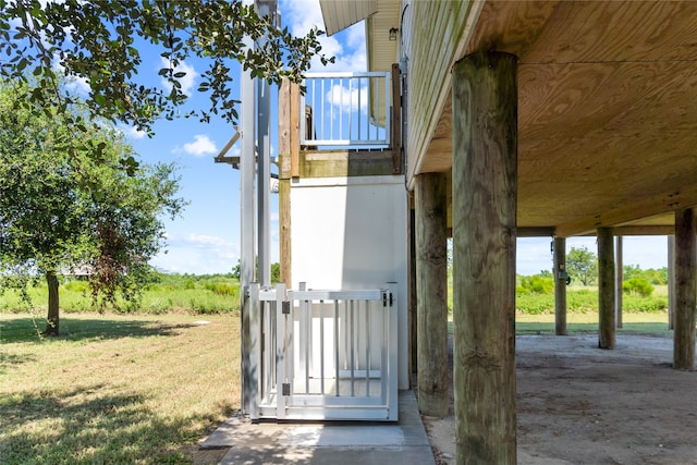 view of exterior entry with a lawn