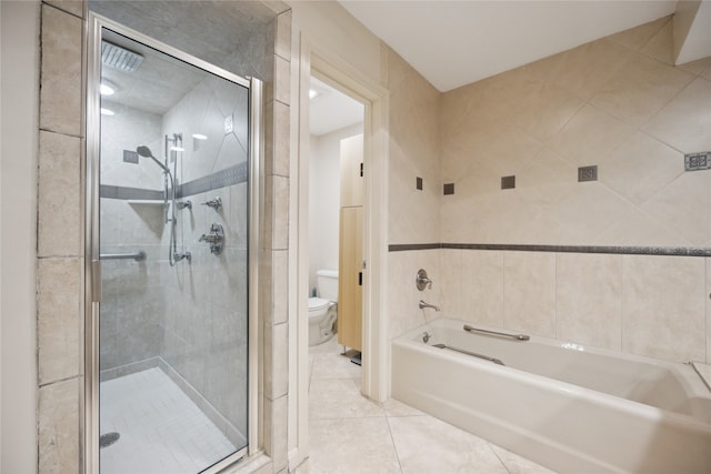 bathroom featuring toilet, independent shower and bath, tile patterned flooring, and tile walls