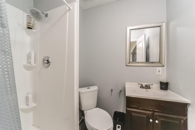 bathroom with a shower, vanity, and toilet