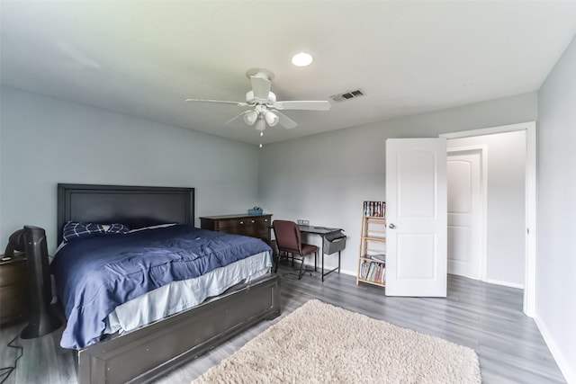 bedroom featuring visible vents, ceiling fan, baseboards, and wood finished floors