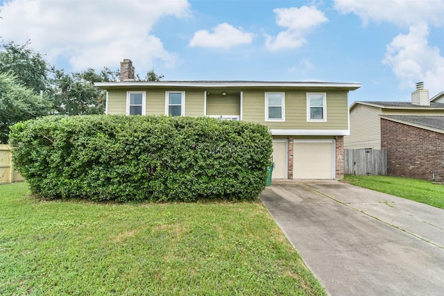 split foyer home with a garage and a front yard