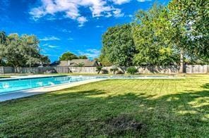 community pool featuring a yard