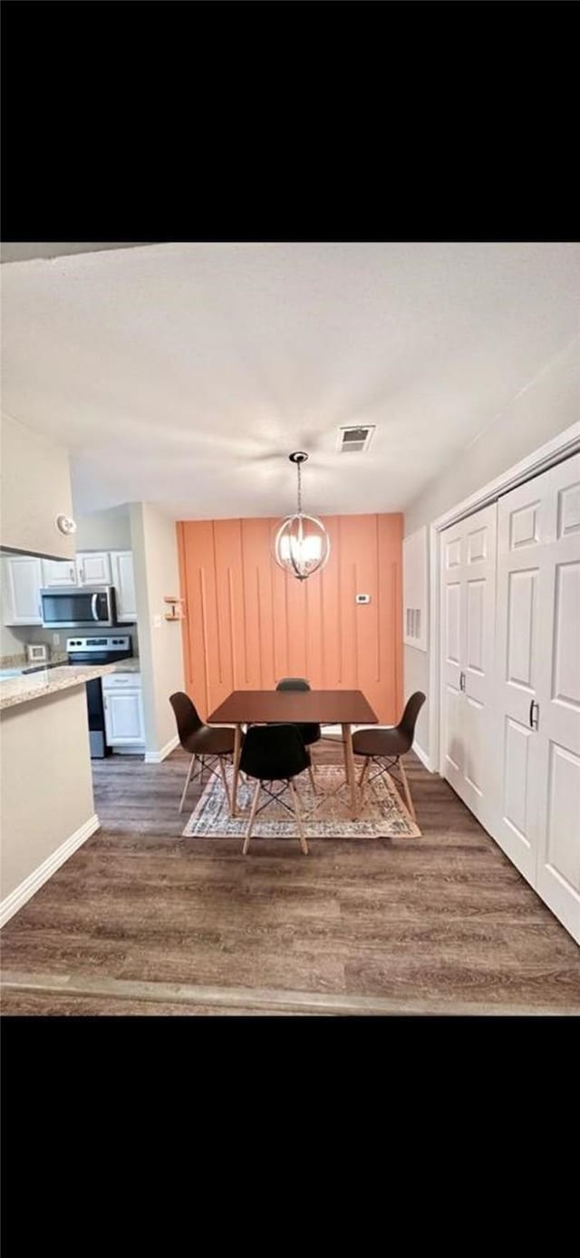 dining space with baseboards, visible vents, and dark wood-style flooring