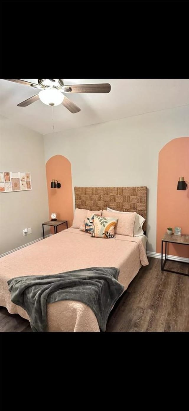 bedroom featuring a ceiling fan and wood finished floors