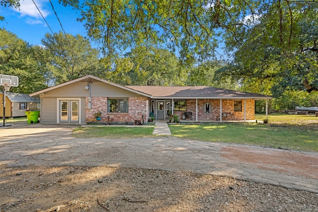 ranch-style home with a front lawn and french doors